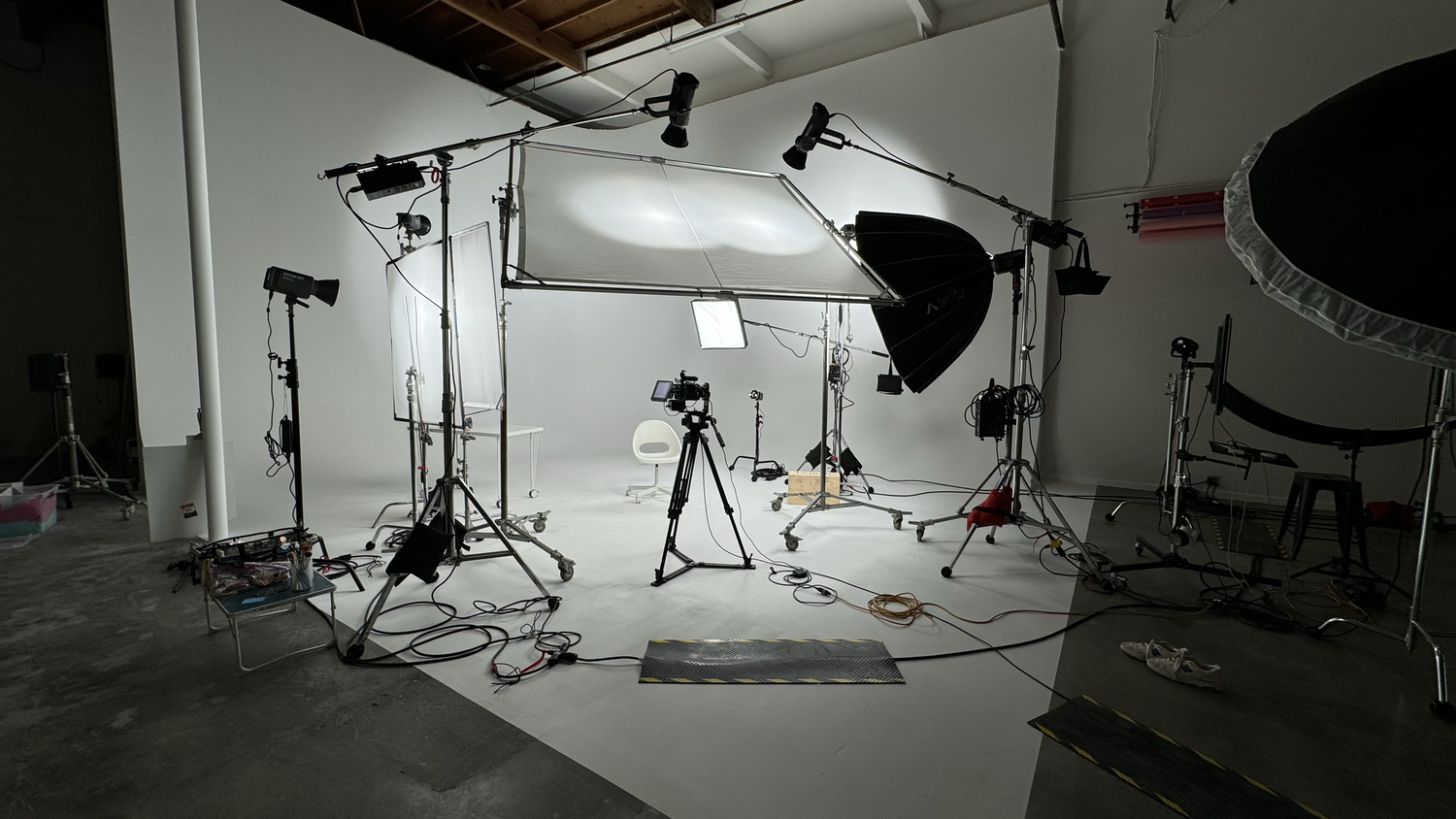 Lighting and grip equipment arranged for a shoot on Cuento’s cyclorama